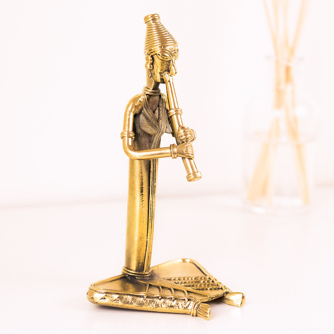 Brass Figurine of a Musician Playing the Flute